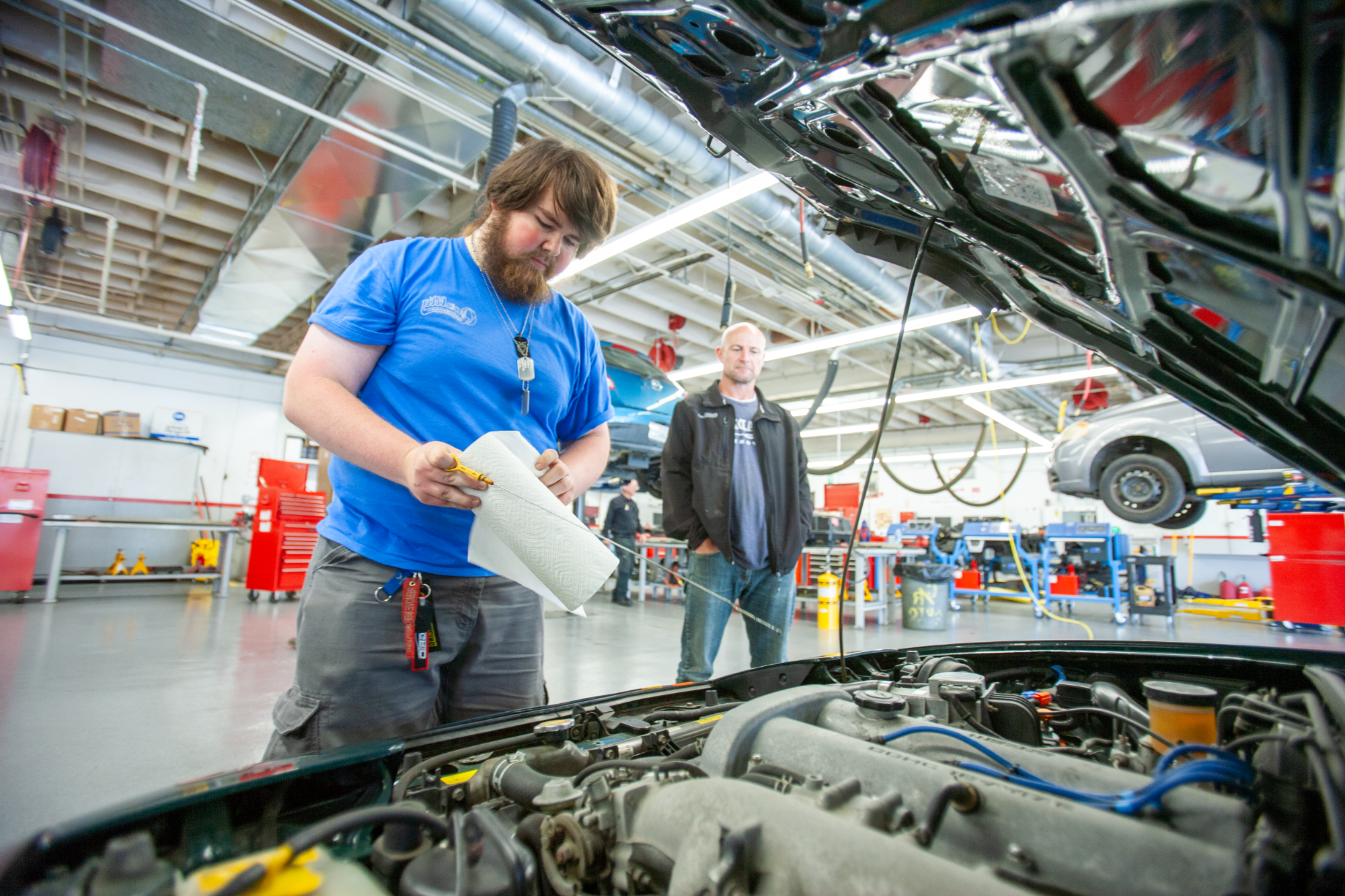 Student with a car engine